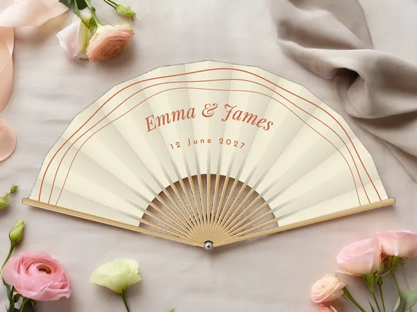 Personalised wedding fan "Retro Waves" with the names Emma & James, three parallel wavy arcs following the edge above, ivory fabric with terracotta print, on a wedding table